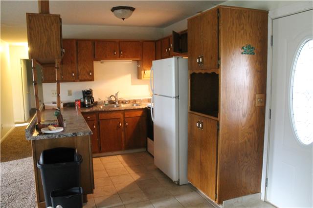 1463 Napier Road Hohenwald, TN 38462 - Photo 6 of 15 U SHAPED KITCHEN WITH TILE FLOOR AND PLENTY OF CABINETS AND COUNTER TOPS