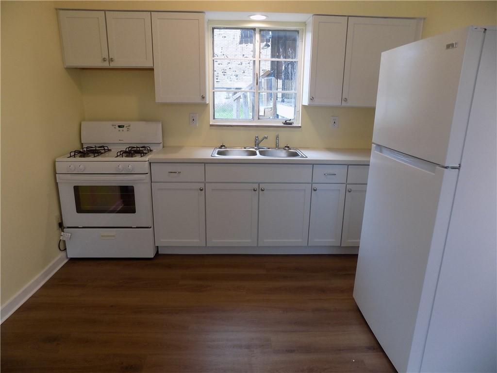 811 Lamont Street McKees Rocks, PA 15136 - Photo 6 of 20 a kitchen with white cabinets and white appliances