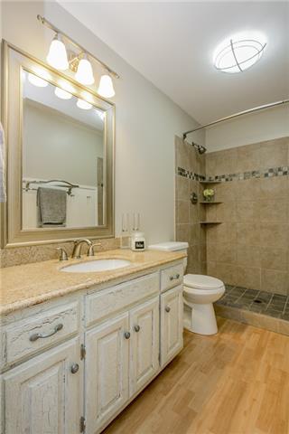 2027 Spring Meadow Circle Spring Hill, TN 37174 - Photo 15 of 20 Updated, clean & spacious bathroom with beautiful tiled shower, laminate flooring, granite counter-tops and lots of storage. What's not to love?