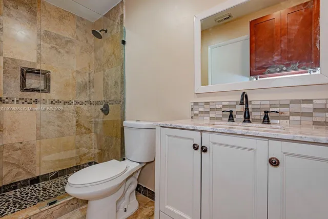 a bathroom with a sink toilet and shower