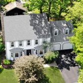 a aerial view of a house with a yard and potted plants