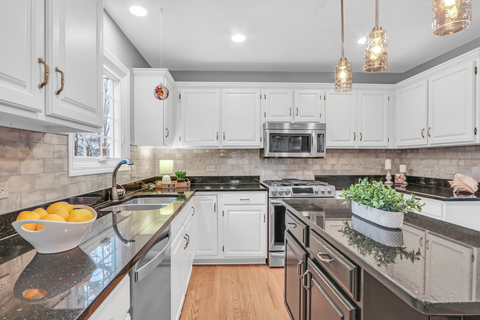 310 Concord Square Gurnee, IL 60031 - Photo 17 of 46 a kitchen with stainless steel appliances granite countertop a sink stove and cabinets