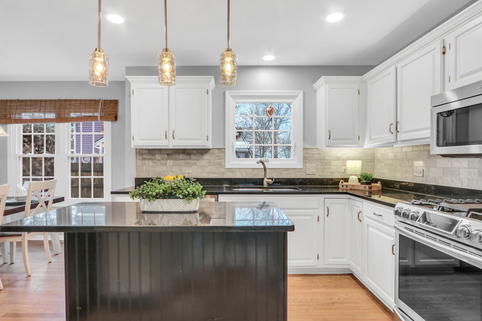 310 Concord Square Gurnee, IL 60031 - Photo 18 of 46 a kitchen with stainless steel appliances granite countertop a stove a sink and a white cabinets