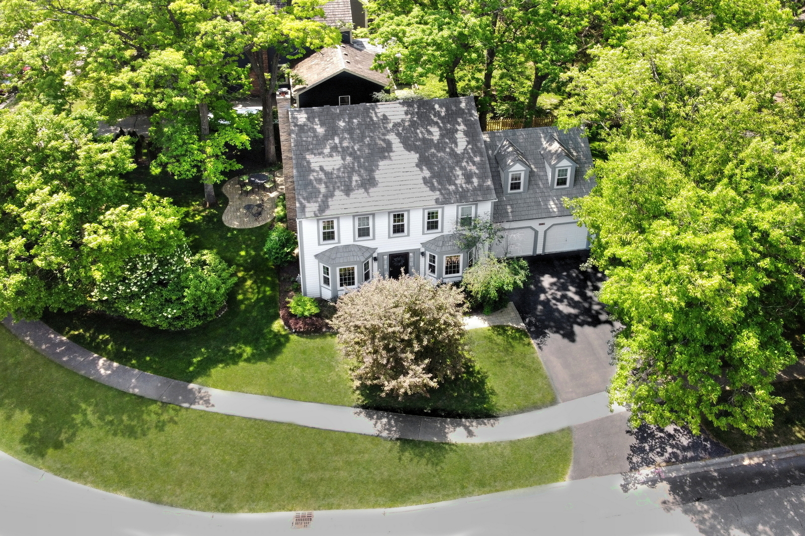 310 Concord Square Gurnee, IL 60031 - Photo 2 of 46 an aerial view of a house with a yard and large trees