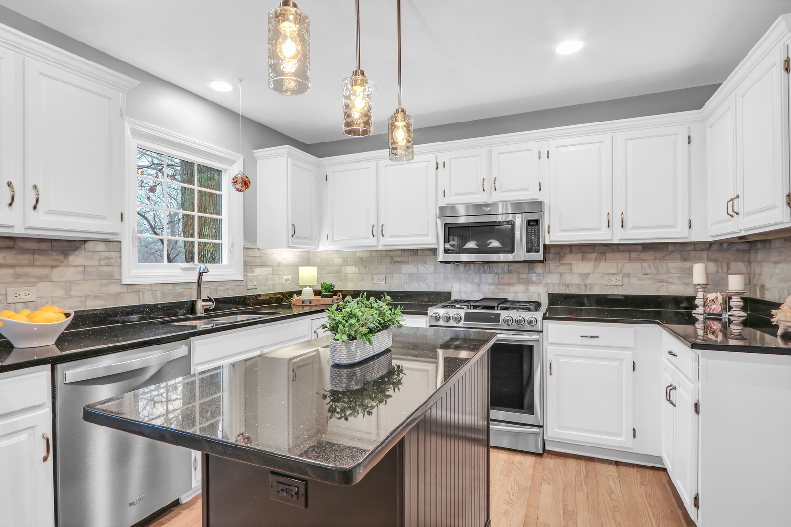 310 Concord Square Gurnee, IL 60031 - Photo 6 of 46 a kitchen with stainless steel appliances granite countertop a sink stove and white cabinets