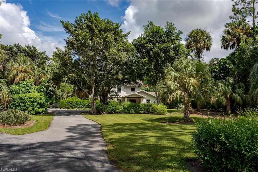 3301 31st Avenue Southwest Naples, FL 34117 - Photo 21 of 22 a view of a fountain in front of a house
