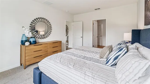 a bedroom with a bed and a dresser