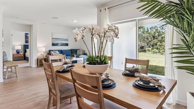 a table with a potted plant and a window