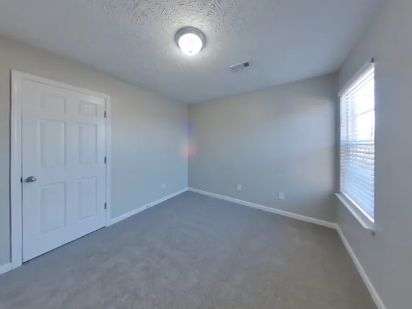 a view of an empty room and a window