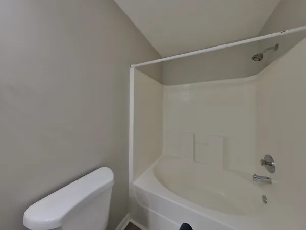 a view of a bathroom with a tub and toilet