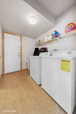 a utility room with a refrigerator a stove a washer and dryer