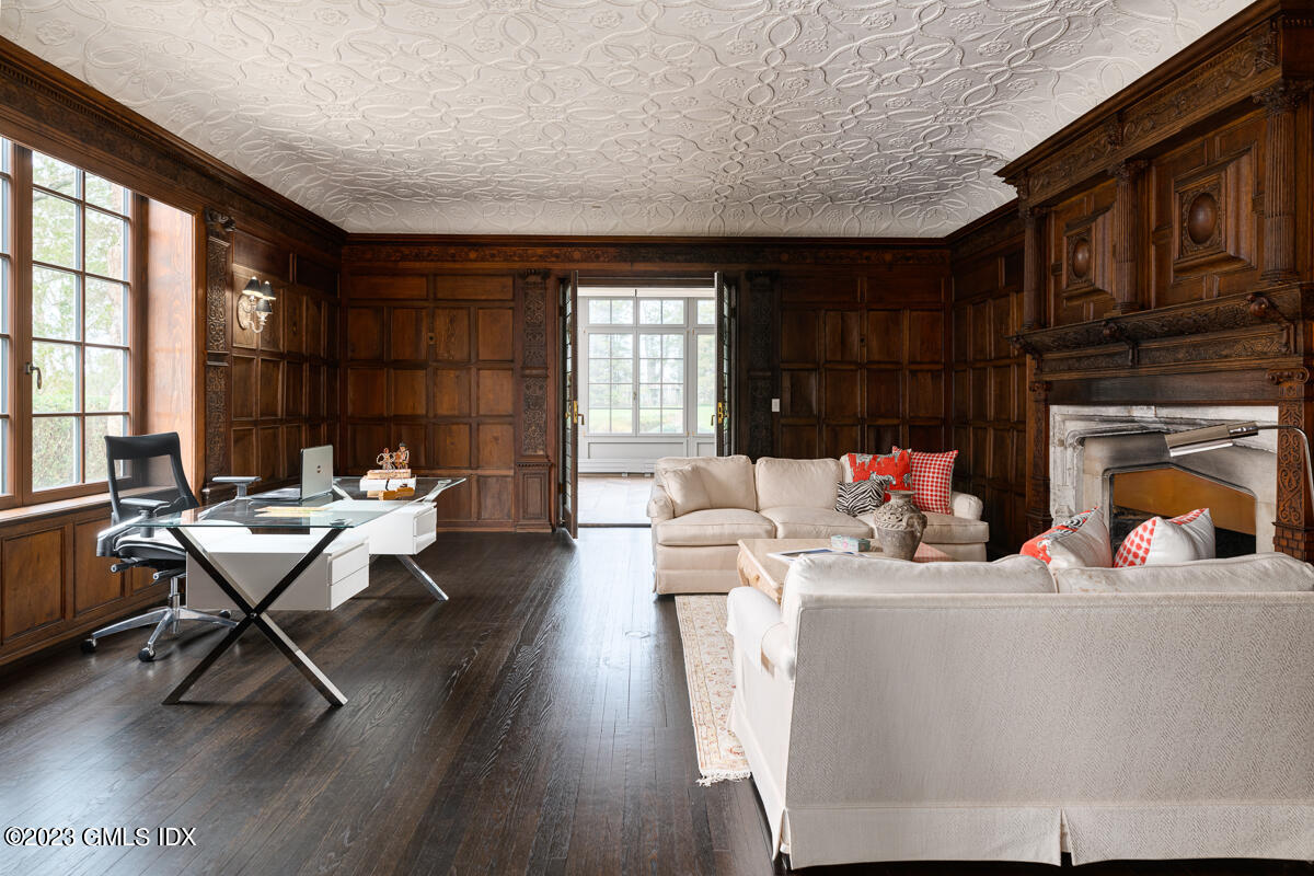 15 Upper Cross Road Greenwich, CT 06831 - Photo 16 of 39 a living room with furniture a fireplace and wood floor