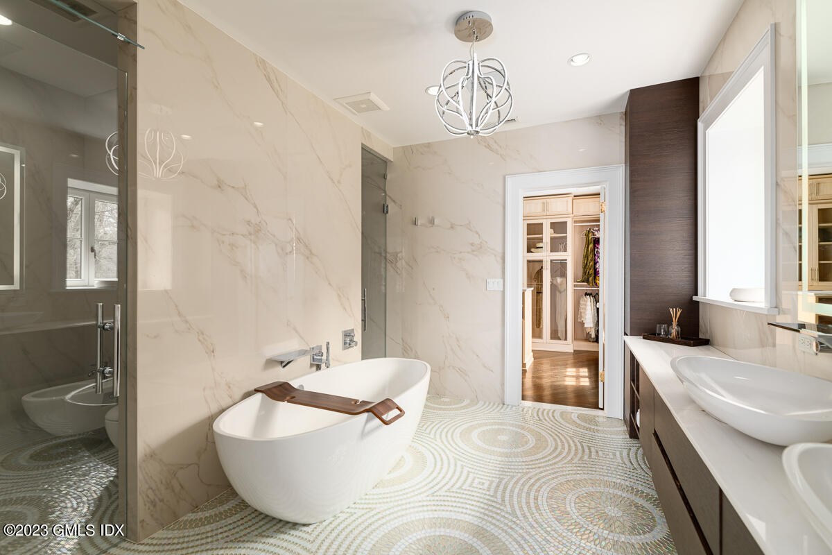 15 Upper Cross Road Greenwich, CT 06831 - Photo 24 of 39 a spacious bathroom with a bathtub and a sink