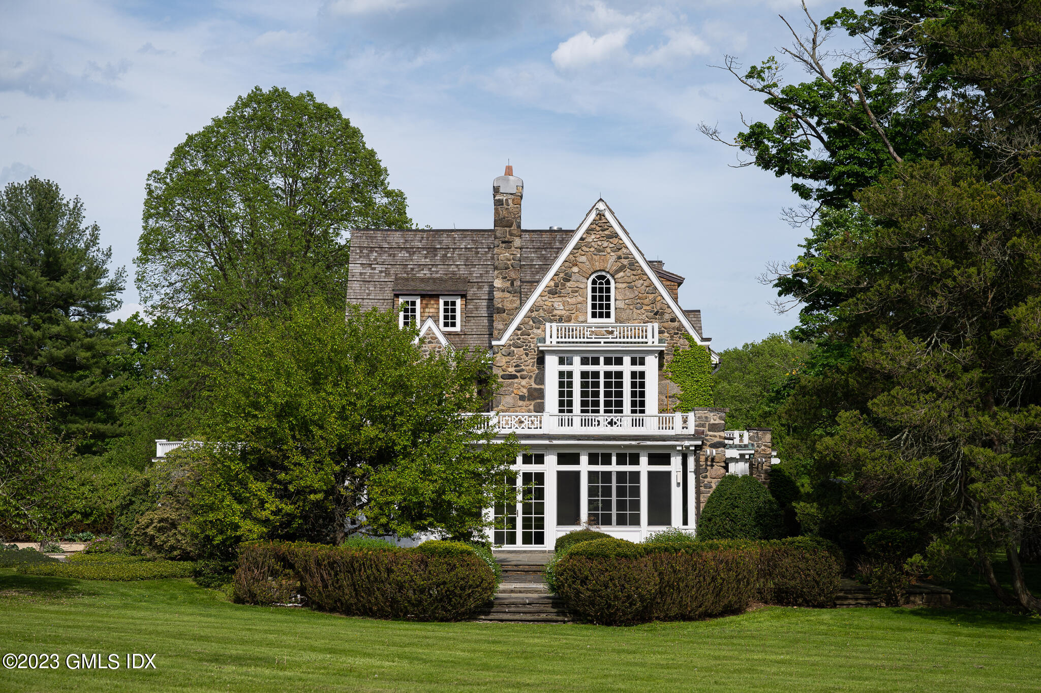 15 Upper Cross Road Greenwich, CT 06831 - Photo 3 of 39 a front view of a house with a yard