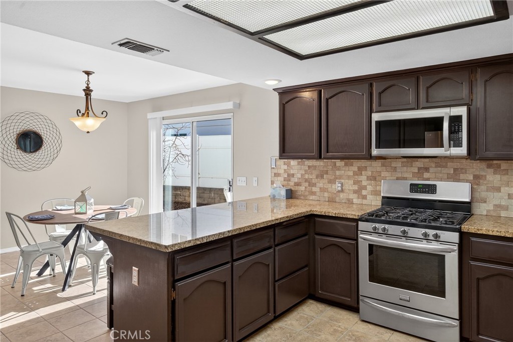 2097 Fallbrook Court Paso Robles, CA 93446 - Photo 11 of 65 a kitchen with stainless steel appliances granite countertop a stove and a microwave