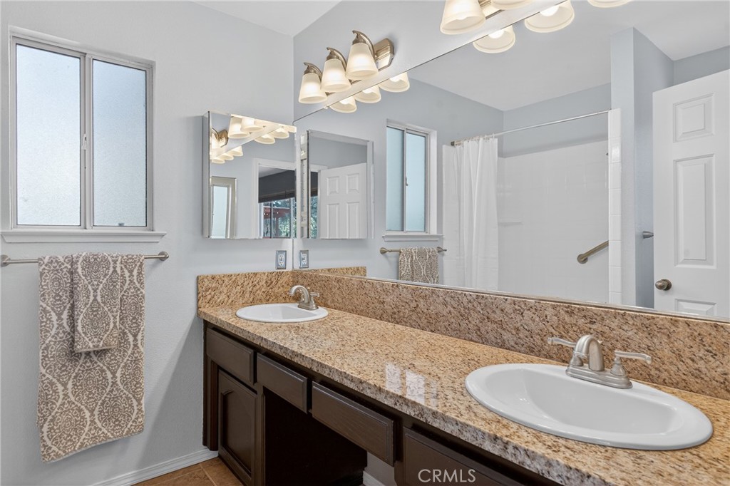 2097 Fallbrook Court Paso Robles, CA 93446 - Photo 22 of 65 a bathroom with a granite countertop sink and a mirror