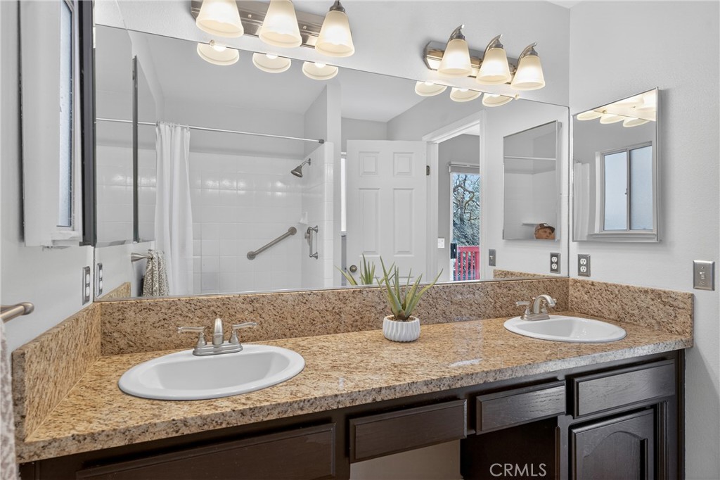 2097 Fallbrook Court Paso Robles, CA 93446 - Photo 24 of 65 a bathroom with a granite countertop sink and a mirror