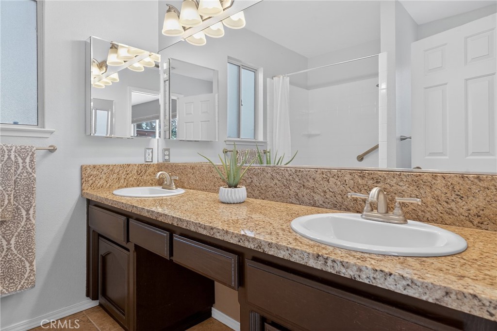 2097 Fallbrook Court Paso Robles, CA 93446 - Photo 25 of 65 a bathroom with a granite countertop sink and a mirror