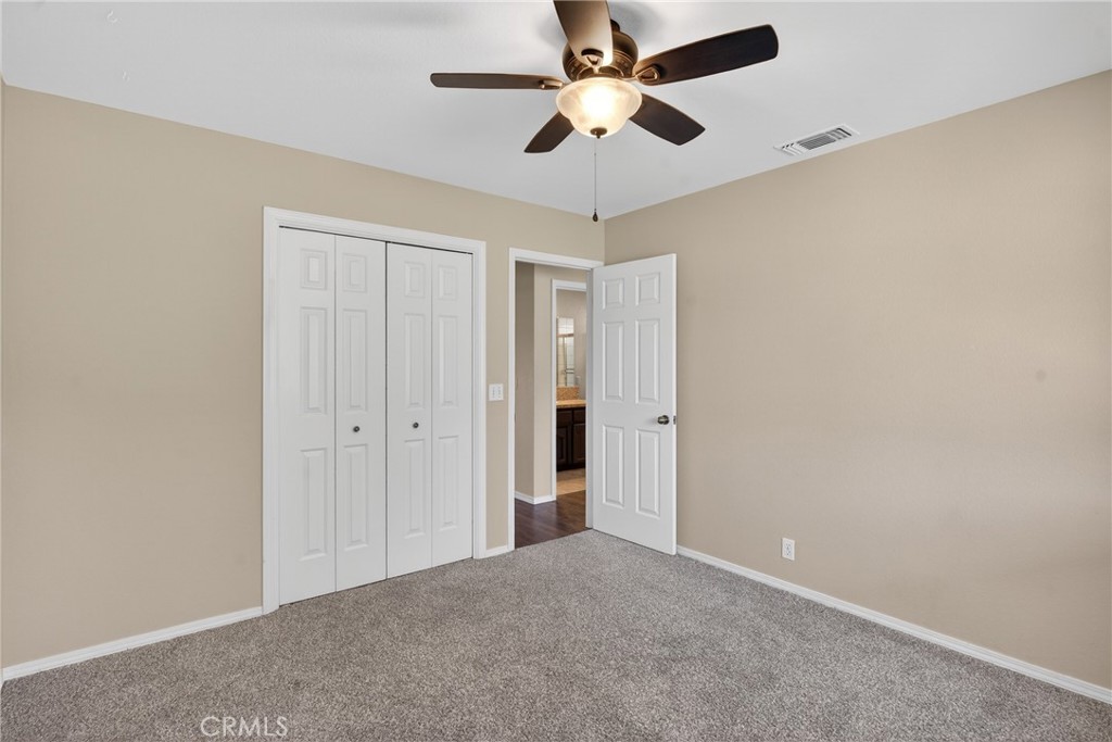 2097 Fallbrook Court Paso Robles, CA 93446 - Photo 28 of 65 an empty room with a ceiling fan and a fan