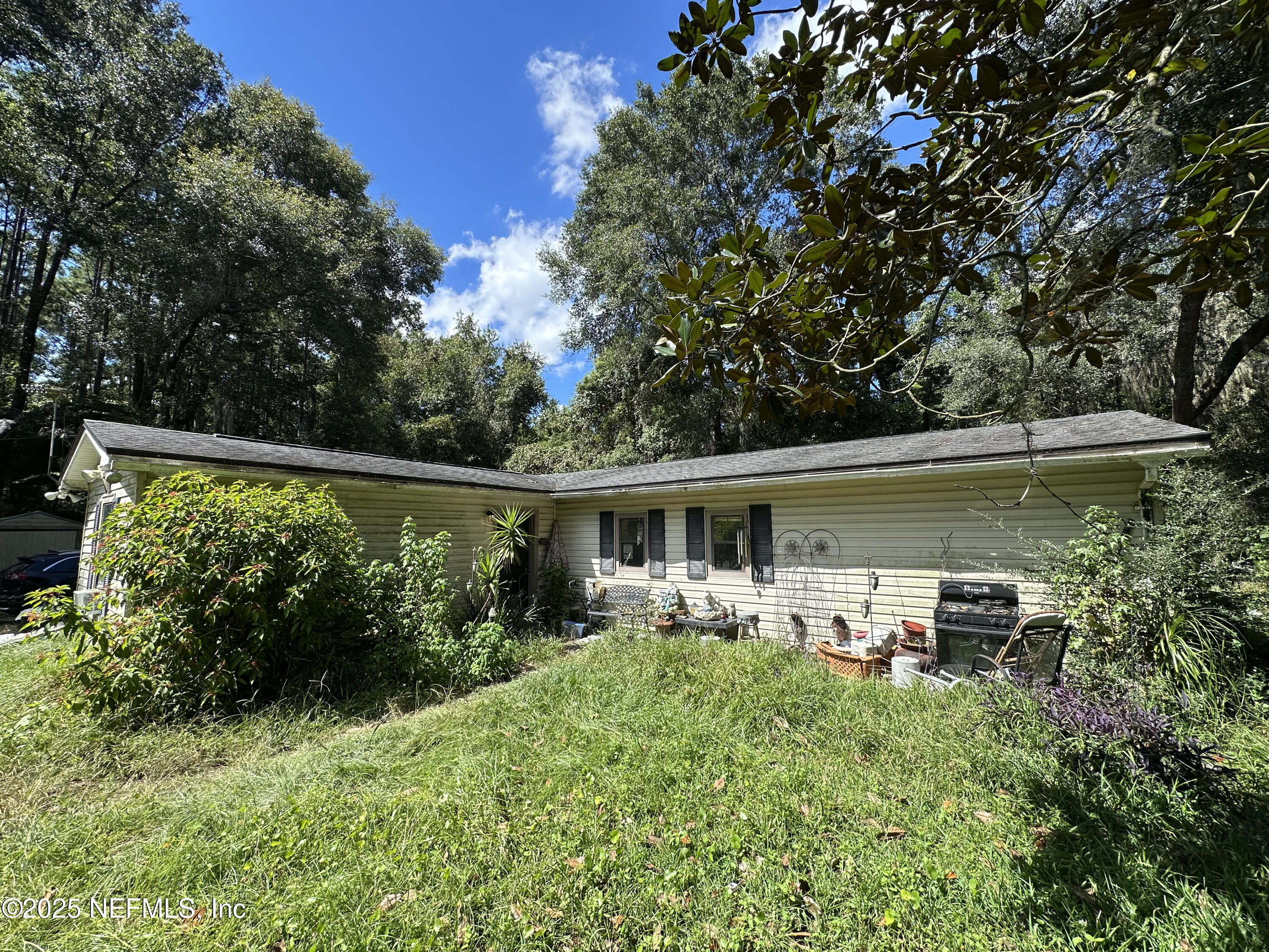 86011 John Street Yulee, FL 32097 - Photo 14 of 18 a front view of a house with garden
