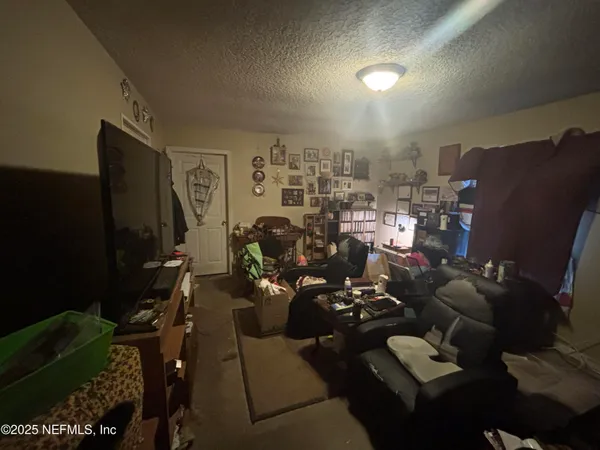 a view of a livingroom with furniture and a flat screen tv