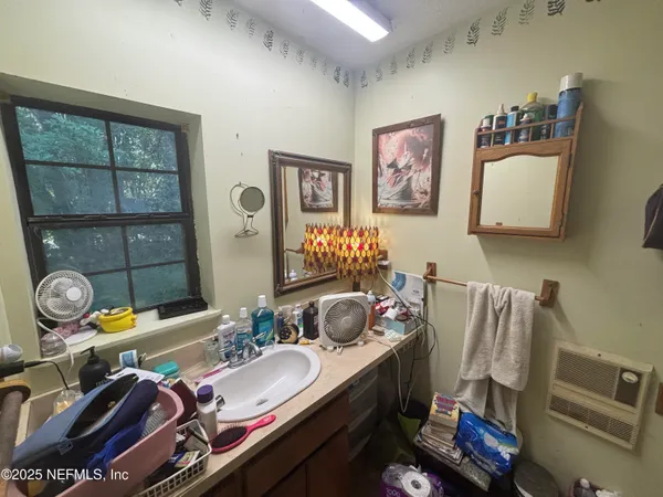 a bathroom with a sink mirror and vanity