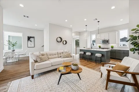 a living room with furniture and kitchen view