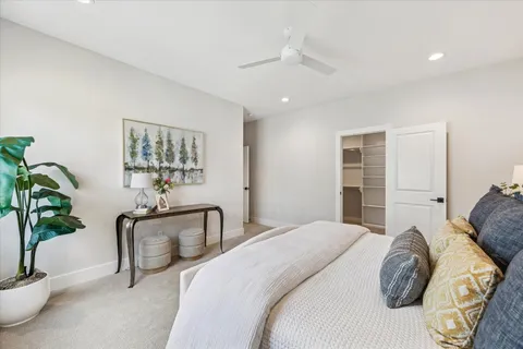 a bedroom with a bed and a potted plant