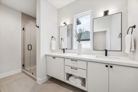 a bathroom with a double vanity sink and mirror