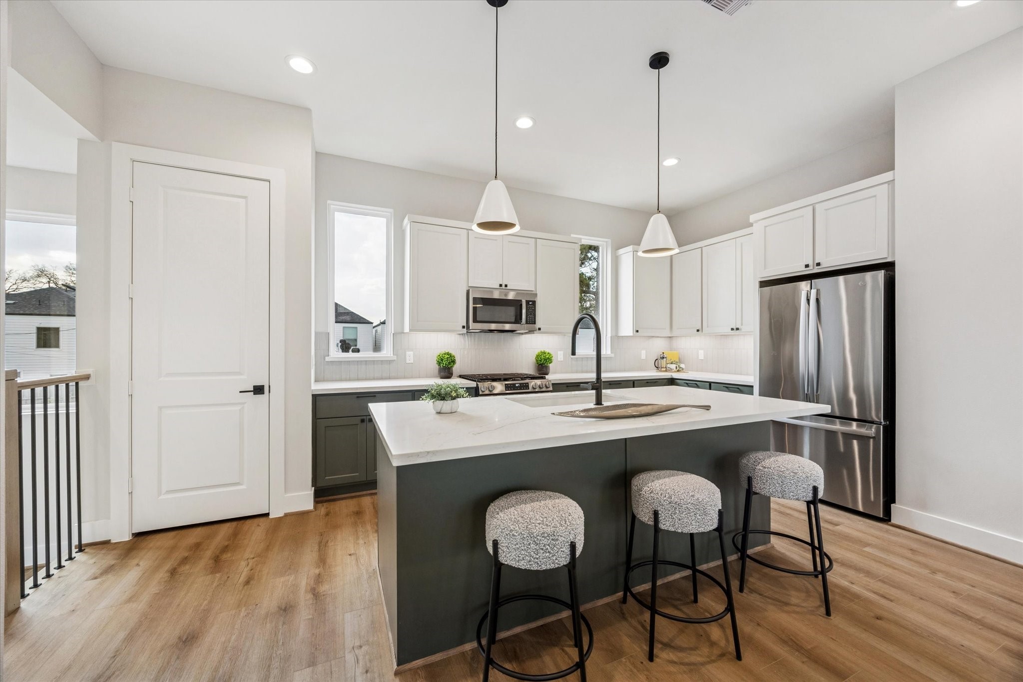 526 Janisch Road Houston, TX 77018 - Photo 2 of 34 a kitchen with stainless steel appliances granite countertop a dining table chairs sink refrigerator and cabinets
