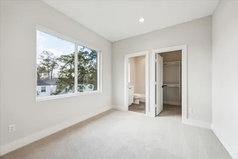 an empty room with a window and a livingroom