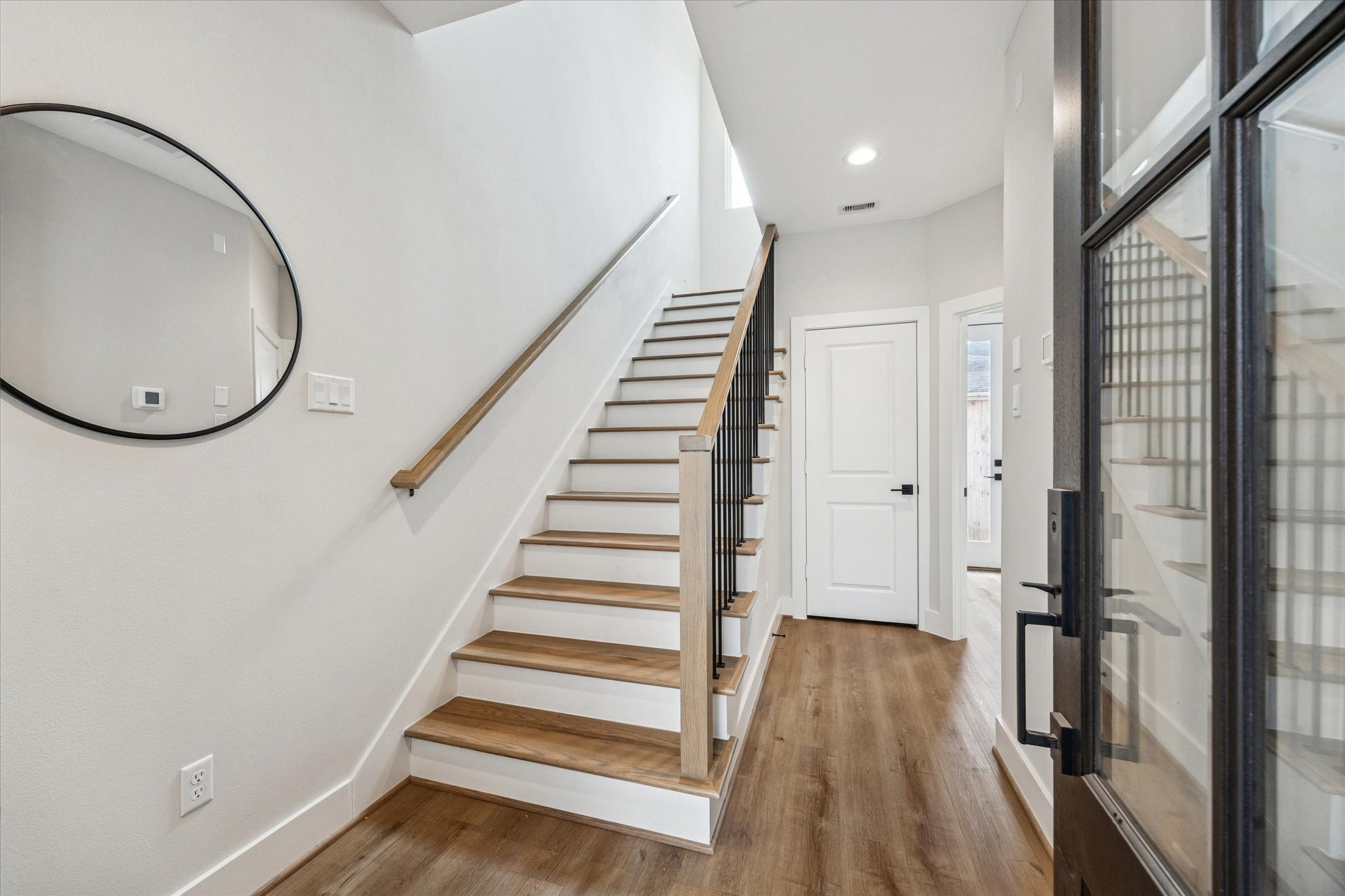 526 Janisch Road Houston, TX 77018 - Photo 28 of 34 a view of a hallway with wooden floor and staircase