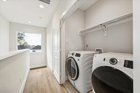 a view of washer and dryer with kitchen in the background