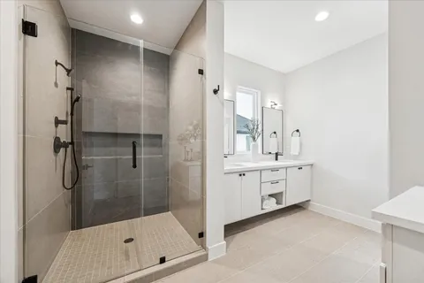 a bathroom with a shower sink and mirror