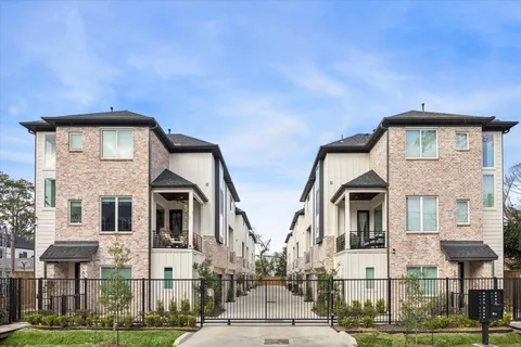 a front view of a residential apartment building with a yard