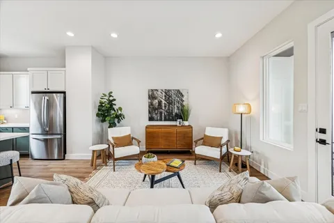 a living room with furniture and kitchen view