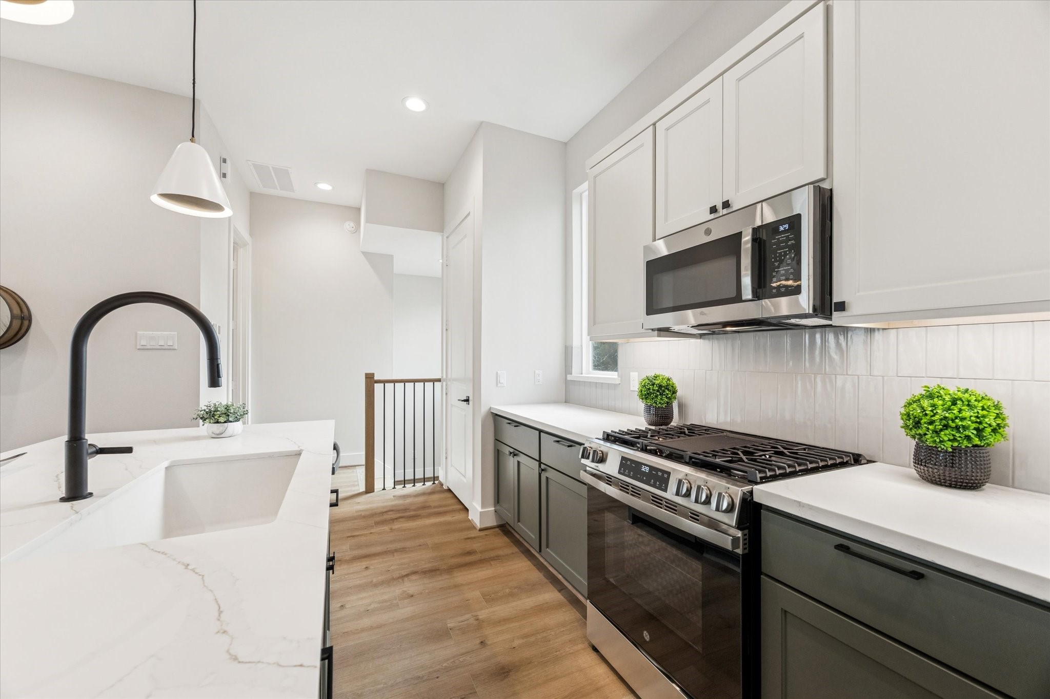 526 Janisch Road Houston, TX 77018 - Photo 10 of 34 a kitchen with stainless steel appliances kitchen island a white stove top oven a sink a counter space and cabinets