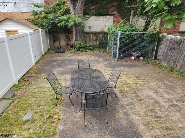 a backyard of a house with table and chairs