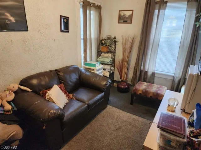 a living room with furniture and a mirror