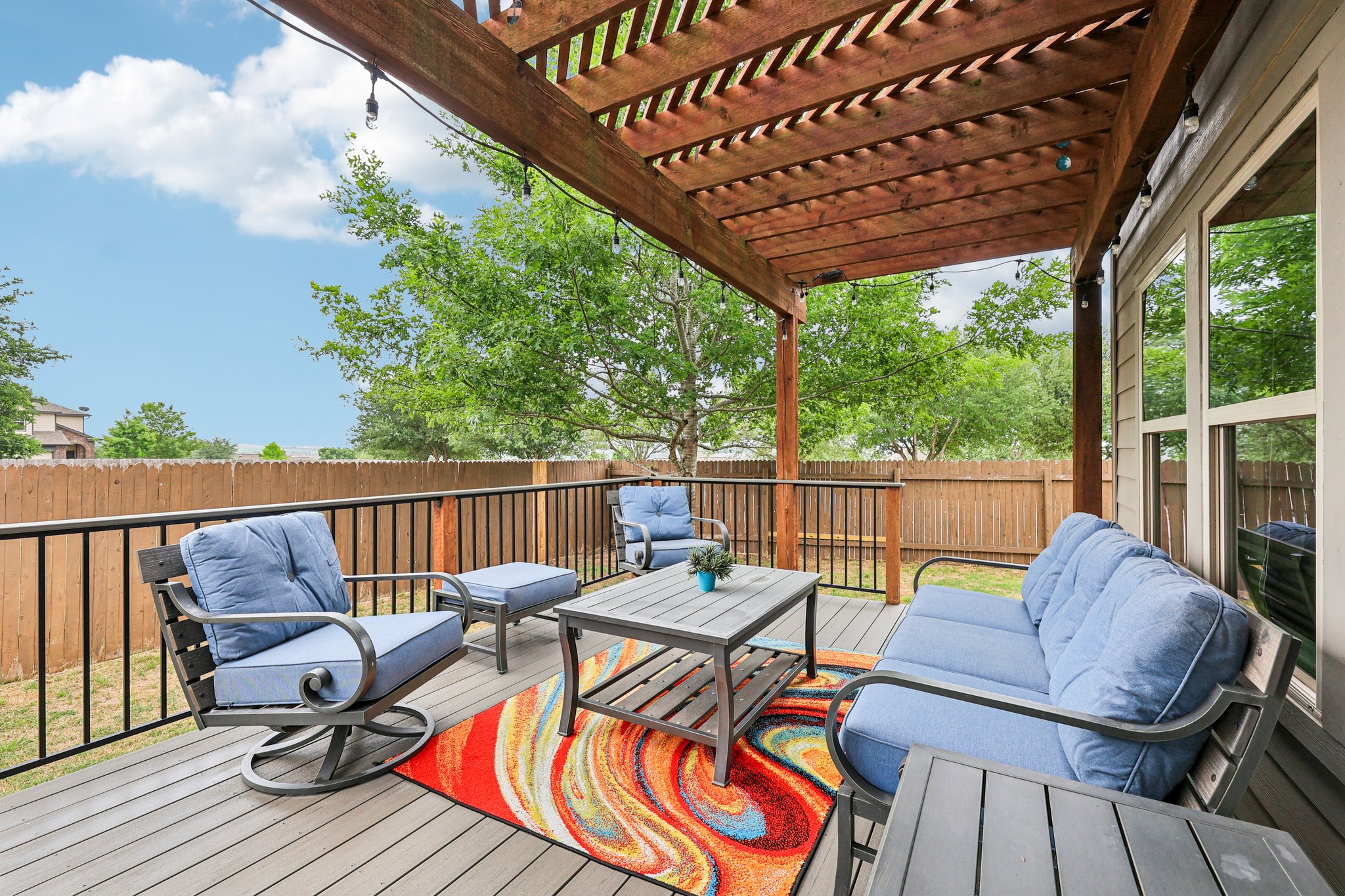 10033 Gertrudis Loop Austin, TX 78747 - Photo 23 of 39 The property features an outdoor deck with a wooden pergola, offering a welcoming space for relaxation