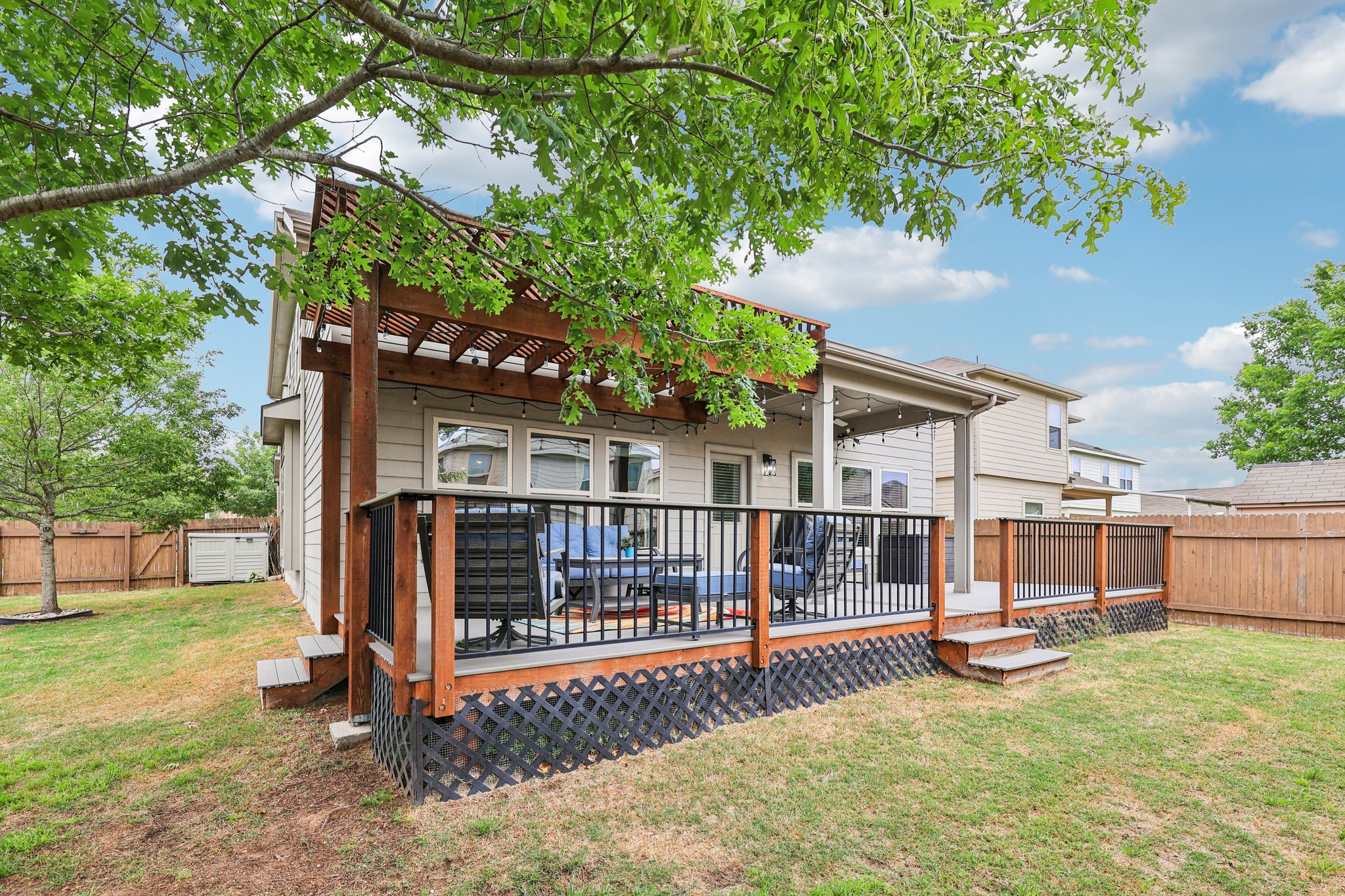 10033 Gertrudis Loop Austin, TX 78747 - Photo 35 of 39 The property features an extensive backyard with a large wooden deck and a pergola