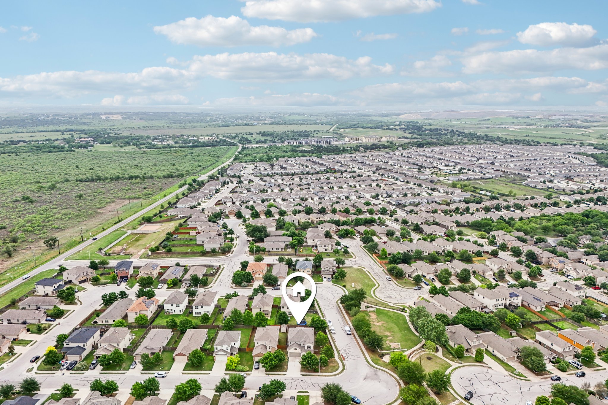 10033 Gertrudis Loop Austin, TX 78747 - Photo 39 of 39 Aerial view of the property located within a developed residential area, featuring a neighborhood with numerous homes and green spaces