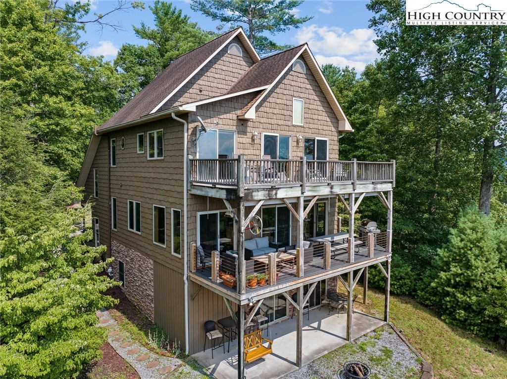 411 West Ridge Drive Ferguson, NC 28624 - Photo 1 of 45 a view of a house with roof deck and furniture