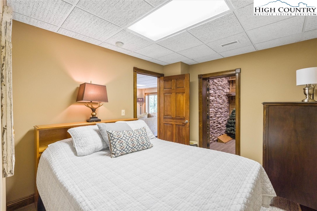 411 West Ridge Drive Ferguson, NC 28624 - Photo 11 of 45 a bedroom with a bed and a lamp