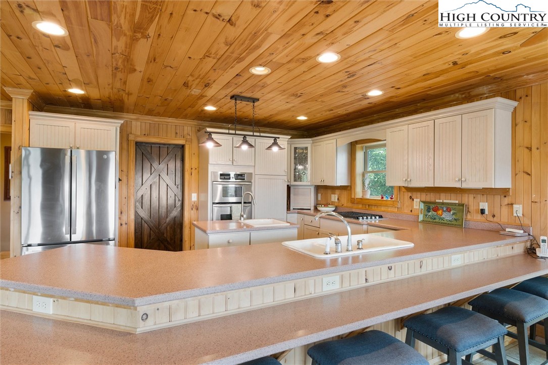 411 West Ridge Drive Ferguson, NC 28624 - Photo 16 of 45 a kitchen with counter top space and stainless steel appliances