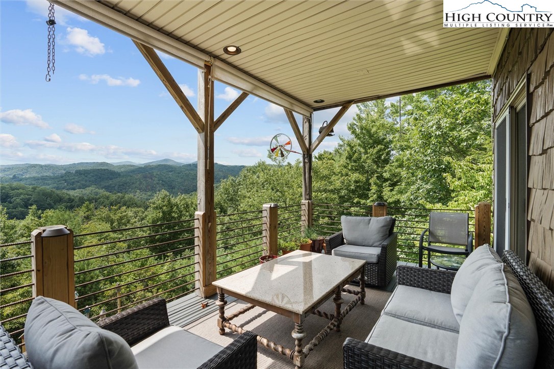 411 West Ridge Drive Ferguson, NC 28624 - Photo 18 of 45 a view of balcony with couch and chairs