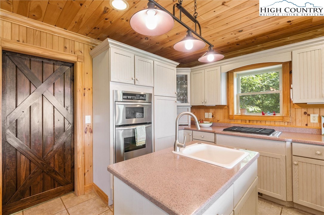 411 West Ridge Drive Ferguson, NC 28624 - Photo 21 of 45 a kitchen with stainless steel appliances a stove a refrigerator and a sink