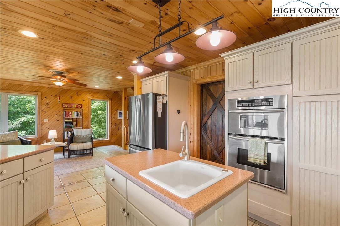 411 West Ridge Drive Ferguson, NC 28624 - Photo 22 of 45 a kitchen with stainless steel appliances granite countertop a sink a stove and a refrigerator
