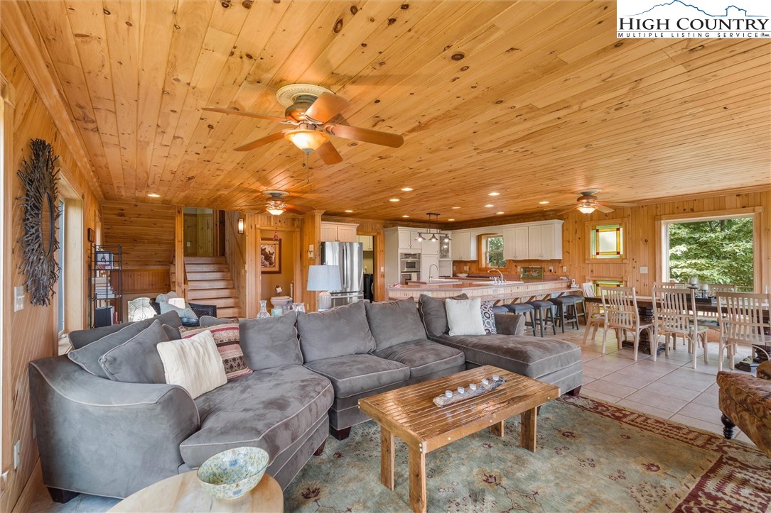 411 West Ridge Drive Ferguson, NC 28624 - Photo 23 of 45 a living room with couches and a dining table with kitchen view