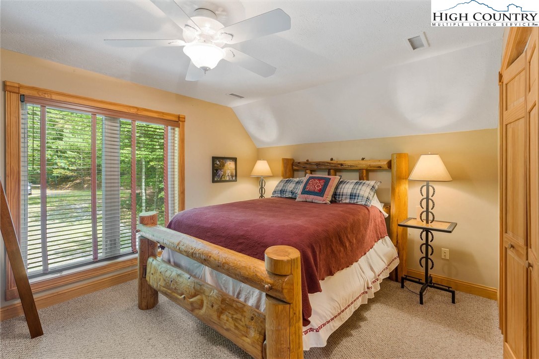 411 West Ridge Drive Ferguson, NC 28624 - Photo 31 of 45 a bed sitting in a bedroom next to a window